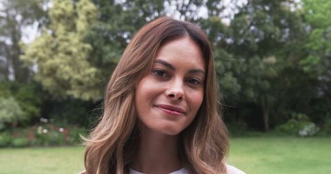 Calm woman enjoying serenity in a lush garden