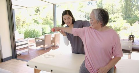 Elderly Woman in Physical Therapy with Professional Help