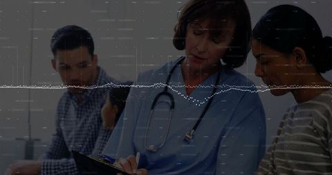 Doctor consulting with patients in medical exam room