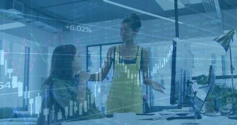 Colleagues analyzing financial charts in modern office setting