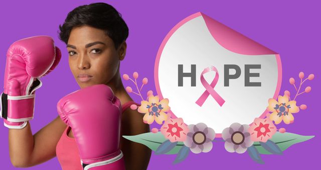 Image of hope text over african american woman wearing boxing gloves on purple background. breast cancer positive awareness campaign concept digitally generated image.