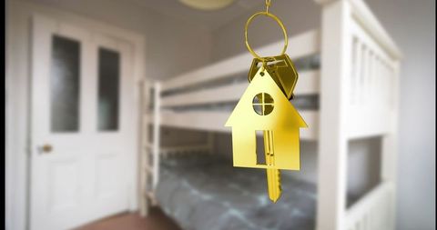 Elegant house-shaped keychain in minimalist bedroom