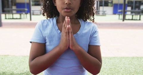 Young Girl Meditating Outdoors at School in Prayer Pose - Download Free Stock Images Pikwizard.com