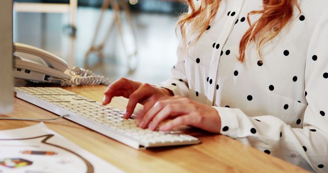 Woman Typing on Keyboard in Modern Office Wearing Polka Dot Shirt - Download Free Stock Images Pikwizard.com