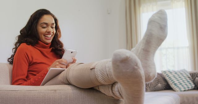 Smiling Woman Relaxing at Home Using Smartphone - Download Free Stock Images Pikwizard.com