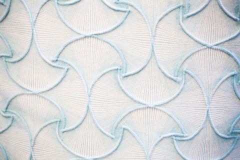 Intricate pastel blue woven textile pattern