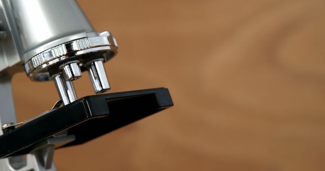 Close-up of Microscope on Brown Background - Download Free Stock Images Pikwizard.com