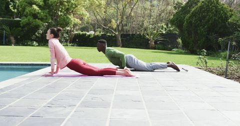 Couple Practicing Yoga in Tranquil Garden Setting