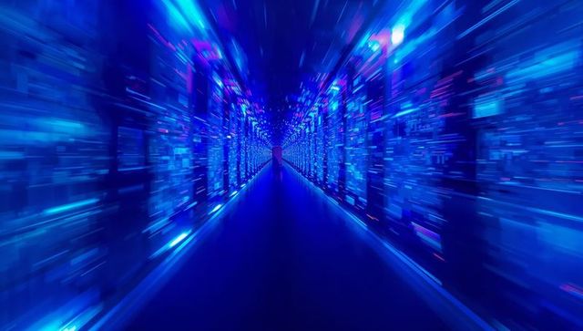 Silhouetted figure walking through neon blue data corridor with servers and led panels