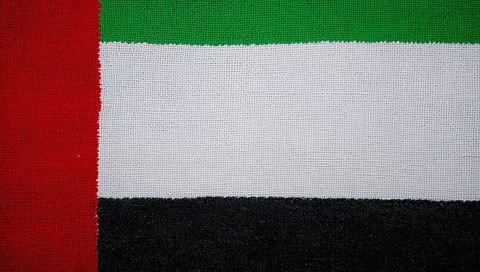 United arab emirates flag textile closeup showing woven macro texture red green white black