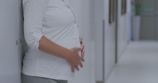 Pregnant woman waiting in hospital hallway - Download Free Stock Images Pikwizard.com