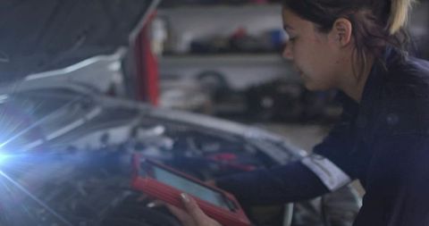 Mechanic Using Digital Diagnostic Tool in Automotive Repair Shop