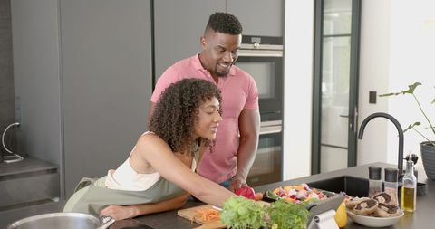 Couple Enjoying Meal Preparation in Modern Kitchen with Fresh Ingredients