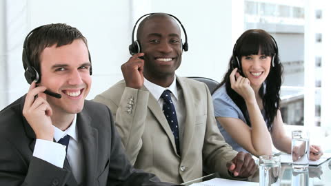 Smiling Customer Service Agents with Headsets in Modern Office