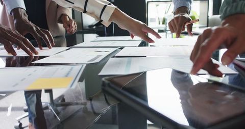 Diverse Team Collaborating and Discussing Project Plans in Office