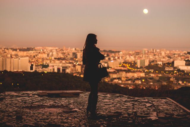 Silhouette of Woman Overlooking City at Sunset with Full Moon - Download Free Stock Images Pikwizard.com