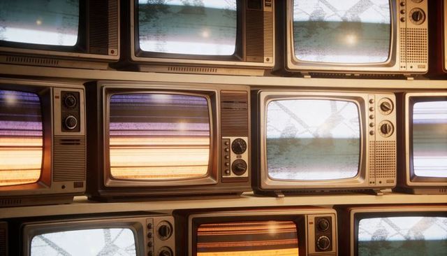 Stacked vintage crt televisions displaying static color bars and rotary dials
