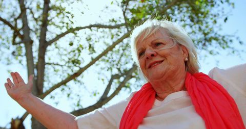 Senior Woman Embracing Wellness in Outdoor Yoga Session