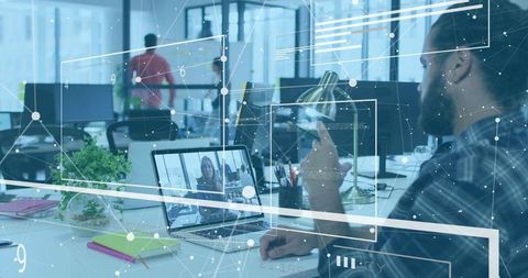 Businessman Collaborating Through Remote Call in Modern Office