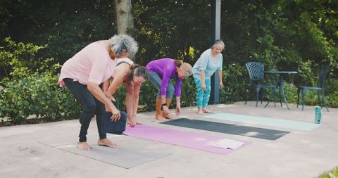 Senior Group Doing Yoga Outdoors in Natural Setting