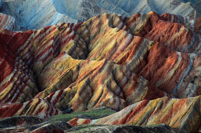Spectacular view of vibrant rainbow mountains in Zhangye Danxia. The rich hues and striking geological formations make it an excellent subject for brochures, travel websites, educational materials, and nature documentaries. Ideal for promoting travel destinations and geology-related content.