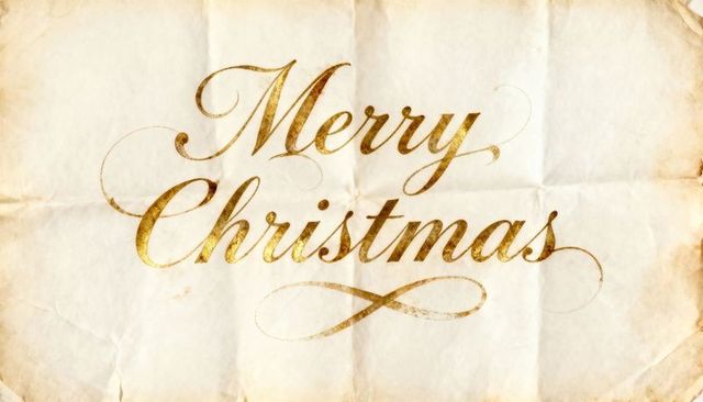 Vintage gold script merry christmas on aged parchment with ornate flourish