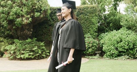 Graduating Students Celebrating Success in Green Outdoor Setting