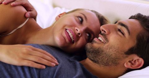 Happy Couple Cuddling in Bedroom Relaxing Together