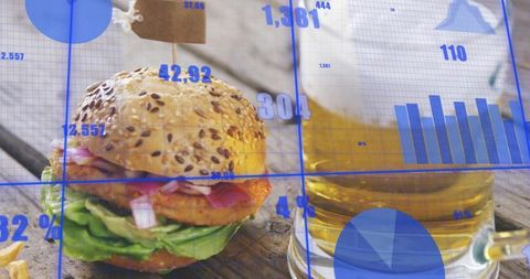 Seeded bun burger and beer with blue analytics overlay, food industry data concept