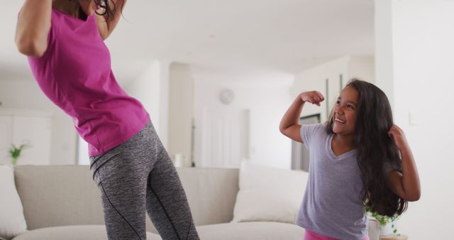 Mother and Daughter Engaging in Playful Exercise at Home - Download Free Stock Images Pikwizard.com