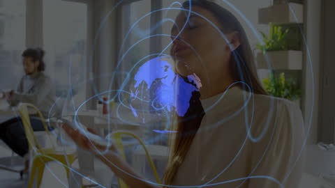 Businesswoman Communicates Through Global Network At Cafe