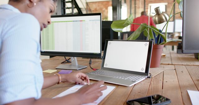 Businesswoman Working on Financial Report at Office Desk - Download Free Stock Images Pikwizard.com