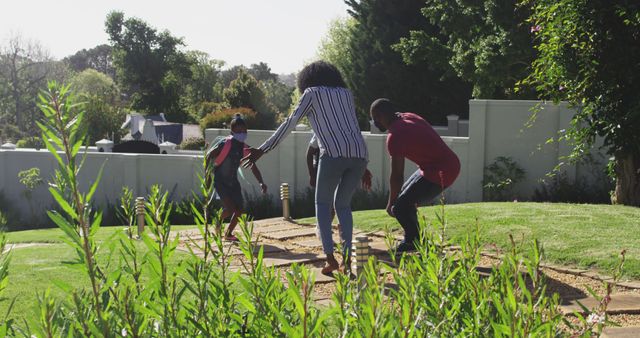 Family Enjoying Outdoor Playtime in Garden - Download Free Stock Images Pikwizard.com