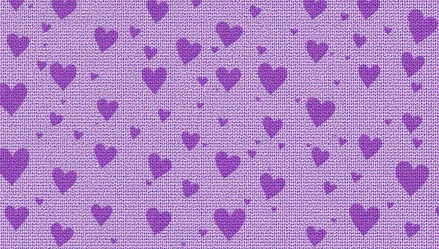 Lavender woven fabric displaying scattered purple heart motifs on textured grid background