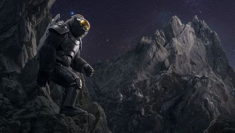 Armored bear astronaut surveying jagged mountain peaks night with gold visor and jetpack