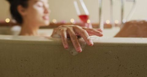 Relaxed Woman Bathing with Wine and Candlelight Bliss
