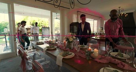 Hosts Preparing Elegant Pink-Accented Dining Table for Intimate Garden Dinner Party