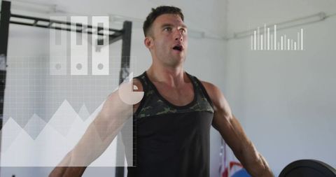 Muscular man lifting weights and exhaling during intense gym workout with data overlay