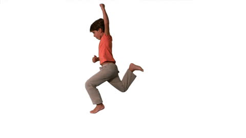 Energetic Boy Jumping in Motion Against White Background