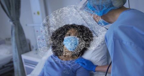 Clinician monitoring patient on hospital bed with digital neural network overlay and ppe
