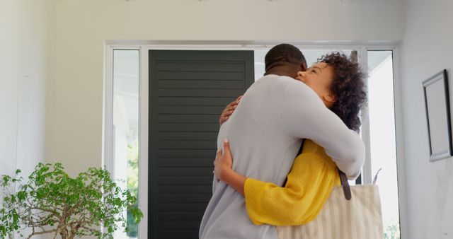 Front view of happy black couple standing in their new house. Black couple embracing each other 4k