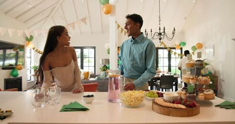 Friends Setting Up for Birthday Party in Modern Home