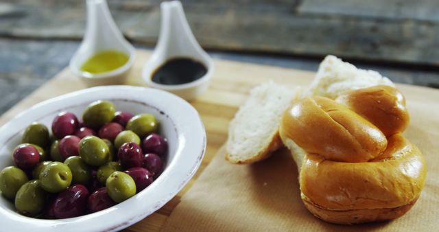 Freshly Baked Bread with Bowl of Green and Black Olives - Download Free Stock Images Pikwizard.com