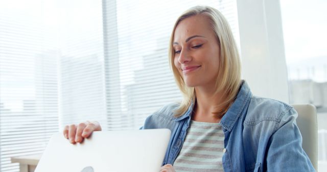 Smiling Woman Closing Laptop in Bright Modern Office - Download Free Stock Images Pikwizard.com