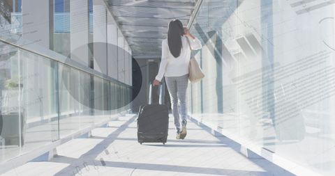Businesswoman Navigating Airport with Traveling Data Analytics