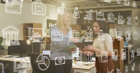 Diverse Business Professionals Engaged in Digital Data Analysis in Office