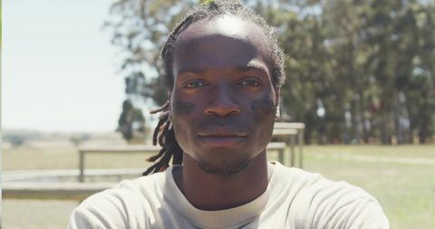 Athlete Showing Determination on Field with Eye Black