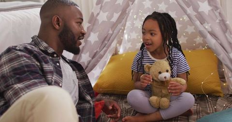 Father and Daughter Bonding Under Play Tent