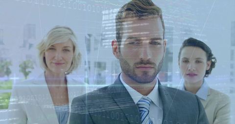 Executive leader standing with team and digital data overlays in modern corporate lobby