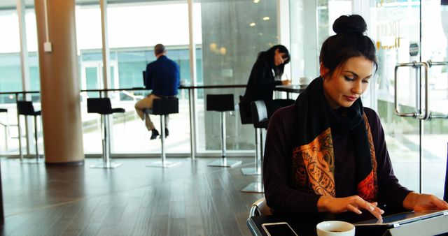 Woman Working on Tablet in Modern Cafe - Download Free Stock Images Pikwizard.com